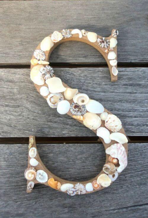 seashells on a wooden letter